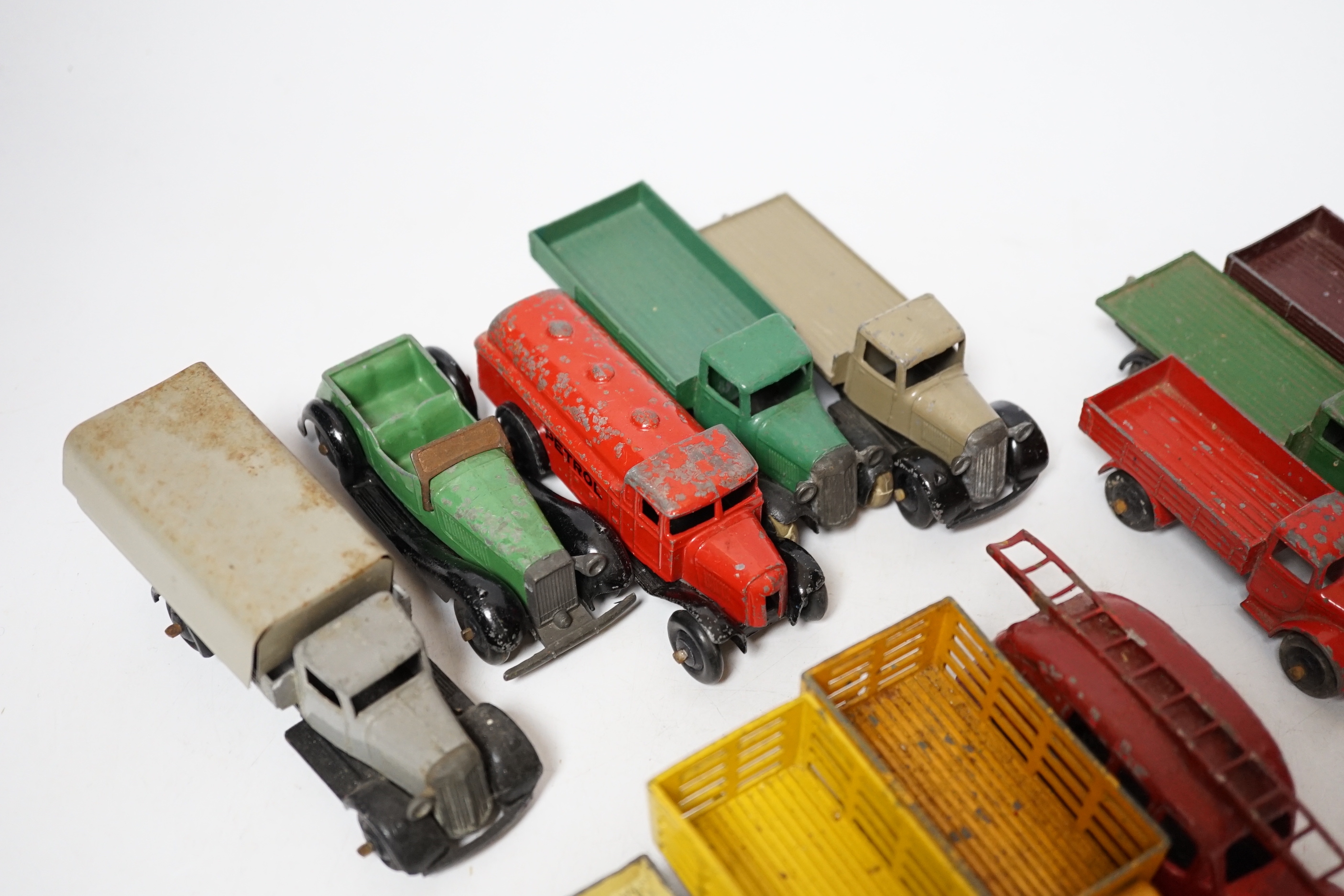 Twenty-five Dinky Toys and Atlas Dinky including a few pre-war examples; Delivery lorries, Market Gardener’s wagon, a Streamlined Fire Engine, a Jaguar SS, Mechanical Horse, etc. together with five Atlas stinky, includin